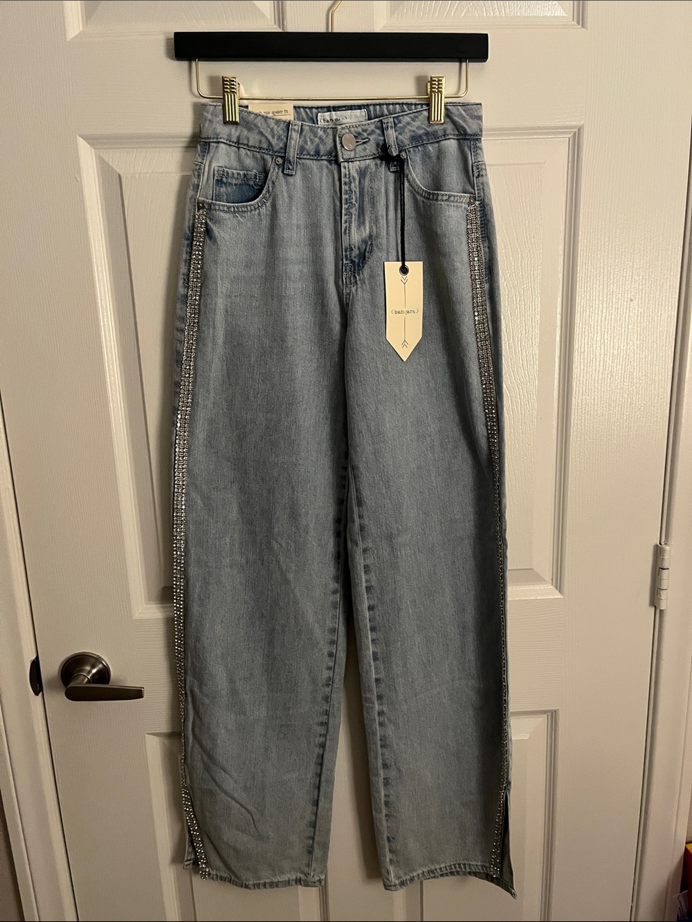Light Wash High Rise Skater/Baggy Jeans with Side Rhinestone Trim and split hem.